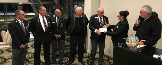 Ms Amanda Cameron, Cranbourne Greyhound Racing Club Manager, presents a donation to Bill Shepherd, Cranbourne RSL Senior Vice President, while RSL Committee Members (left) and Greg Carter, Cranbourne Greyhound Club President,  (Right) look on. 