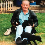 Norm Walls with a litter of greyhound pups.