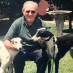 Norm Walls at home with two of his greyhounds.