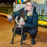 Hand The Hustler with handler Lori Courts after collecting the Cup Night Stayers Trophy and a $15,000 winner's cheque.