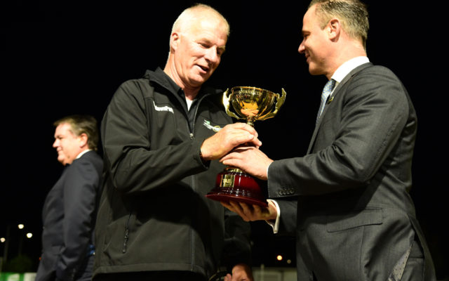 TAB's Glenn Lee presents the TAB Melbourne Cup trophy to David Geall.